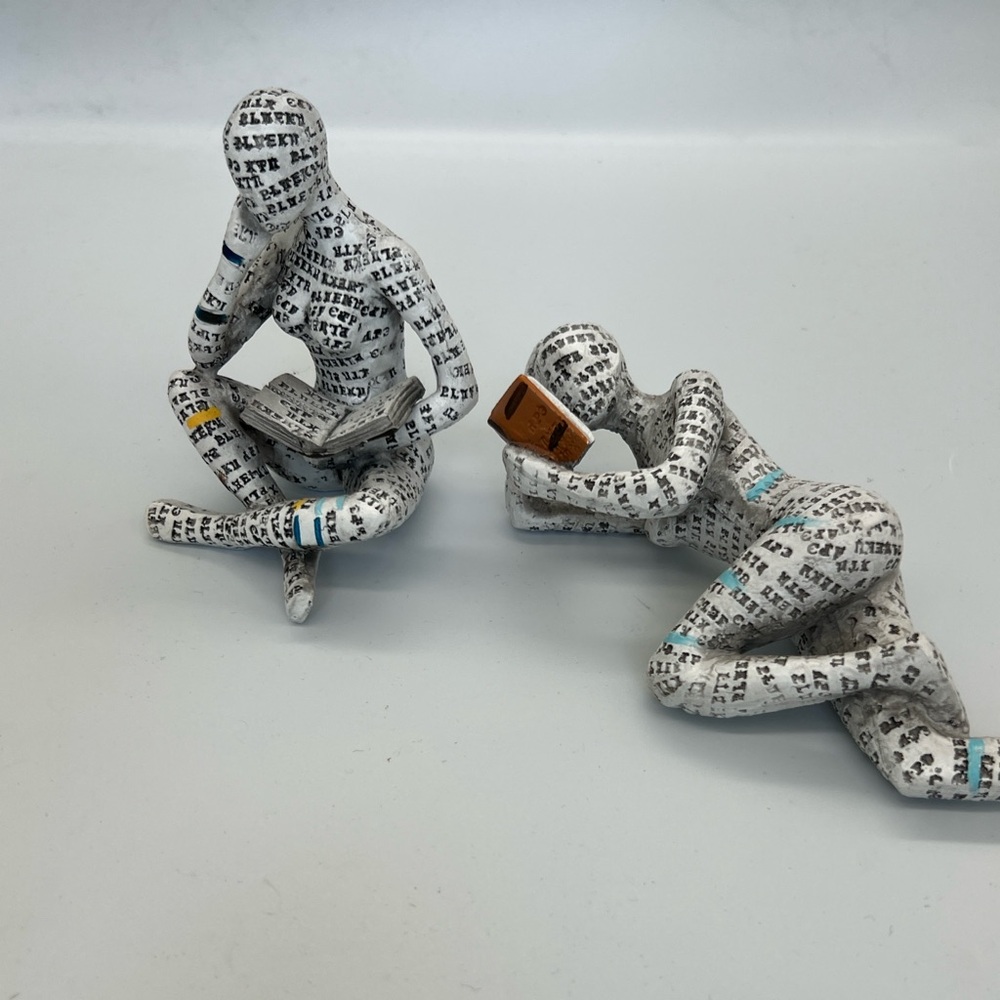Set of Two White Newspaper Print Reading Figurines